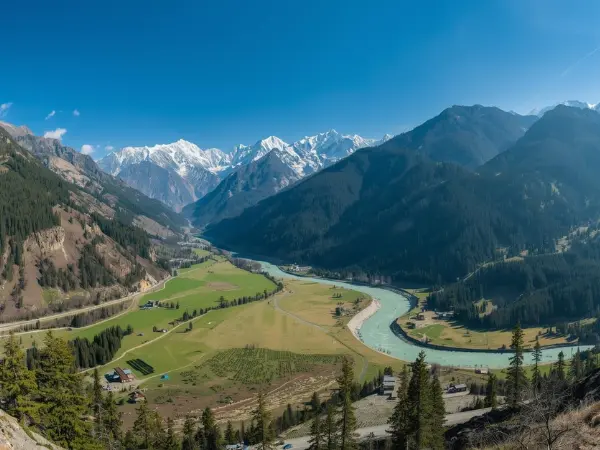 Uttarakhand travel guide showing scenic valley with river and Himalayan mountains